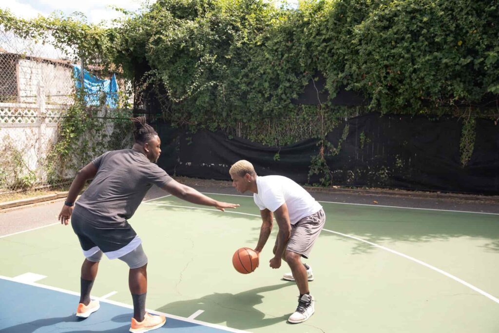 Two men are playing basketball
