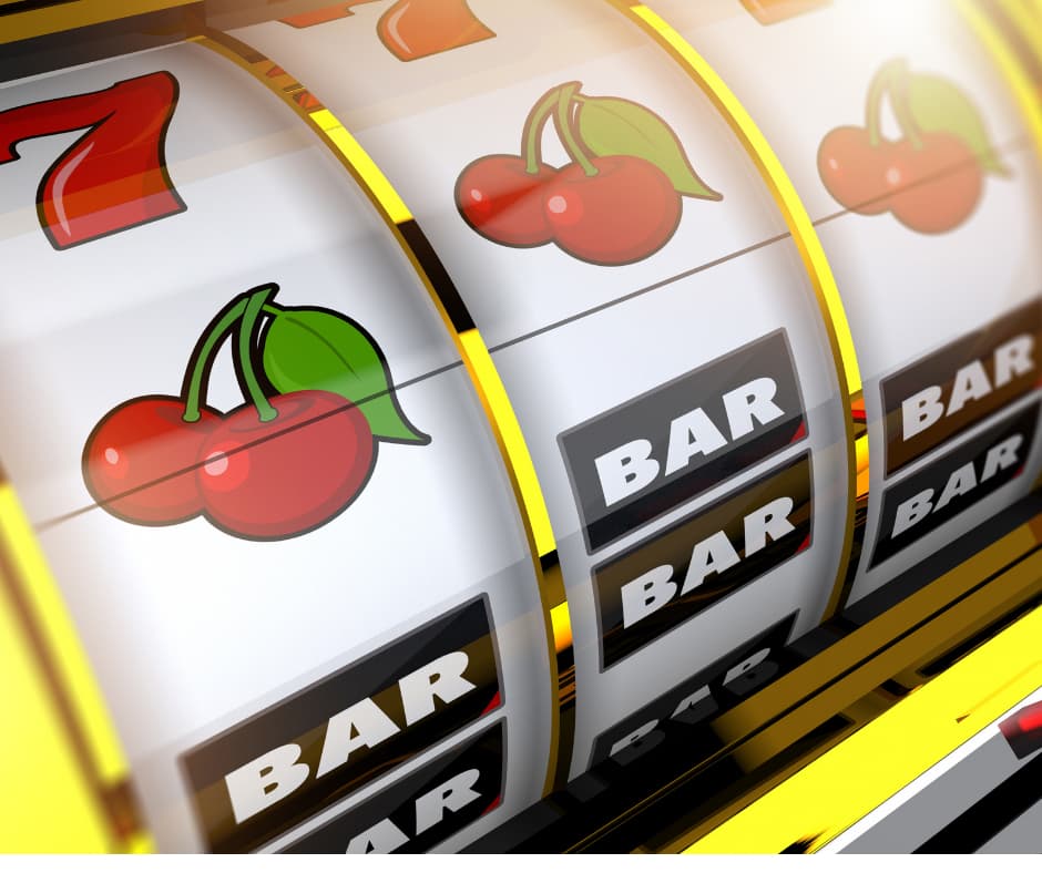 Close up of the three wheels of a classic slot machine. From top to bottom, each wheel has 7, a cherry, and BAR BAR. The first and last wheel are aligned, with the central wheel slightly misaligned to these two.